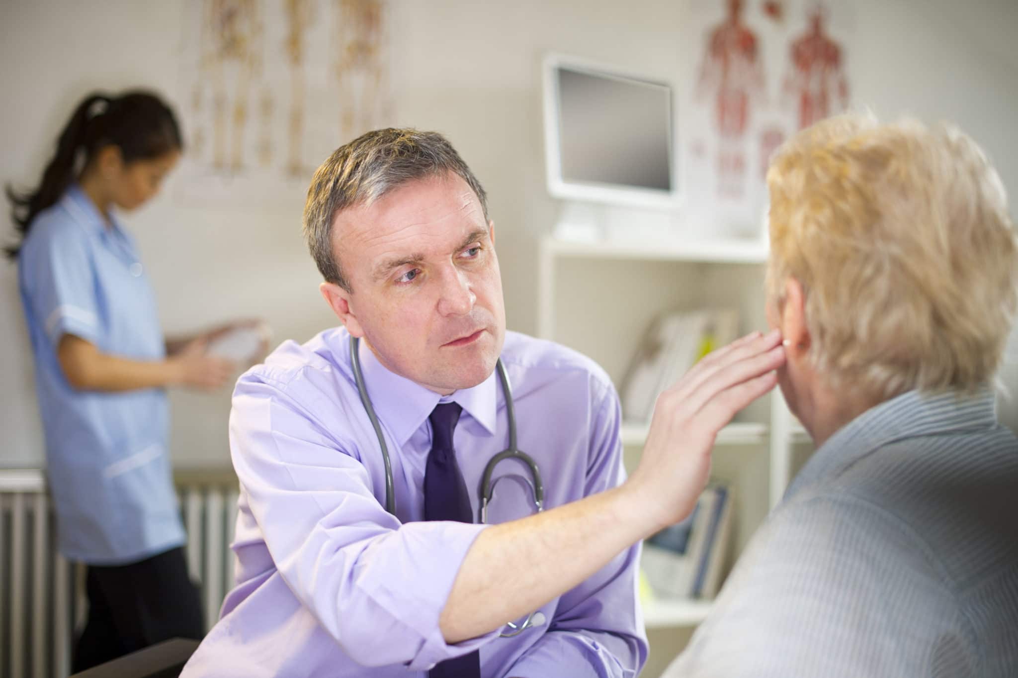 doctor checks out patients ear